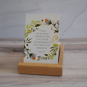 Come, let us shout joyfully to the Lord, shout triumphantly to the rock of our salvation! Psalm 95:1 Bible Verse Card in display stand for Christian home decor or office