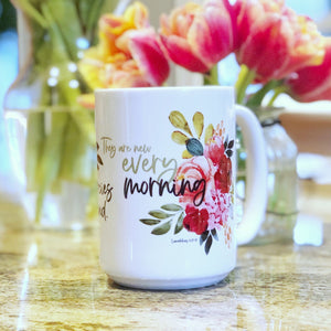Christian coffee mug with flowers and Bible verse: His mercies never end. They are new every morning