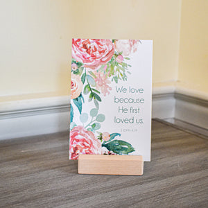 We love because he first loved us. 1 John 4:19 Scripture card for a religious gift for mom.