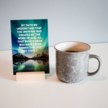Load image into Gallery viewer, Hebrews 11:3 By faith we understand that the universe was created by the word of God, so that what is seen was made from things that are not visible - Memory verse scripture card with wooden stand